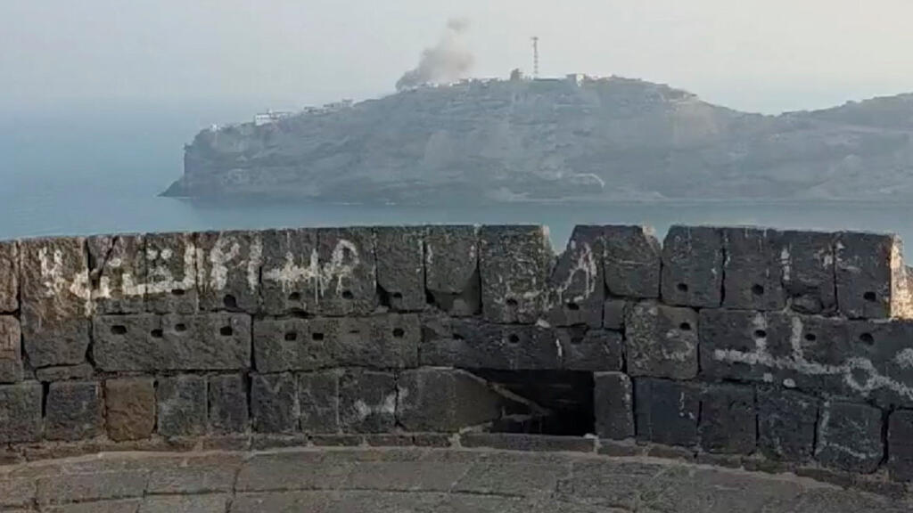 Smoke trailing above the palace fortifications on the Aden coastline hill