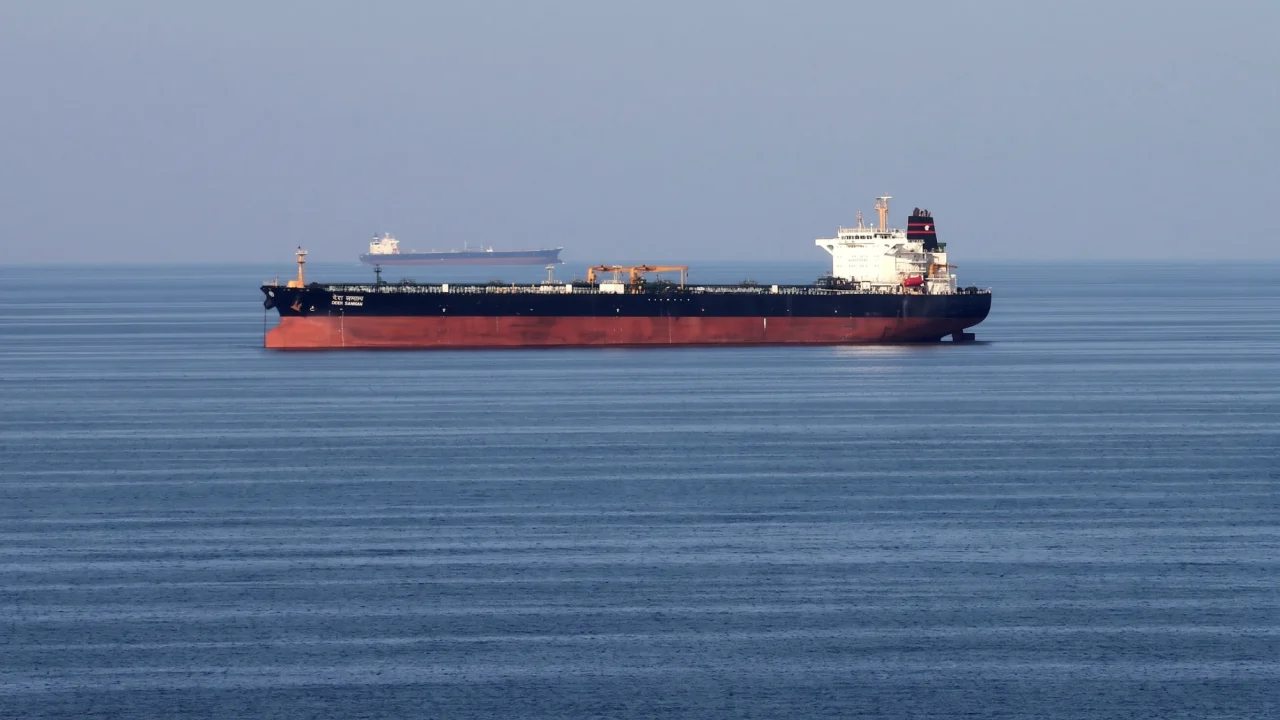 An oil tanker vessel sailing through the strategic Strait of Hormuz waterway amid escalating U.S.-Iran military hostilities